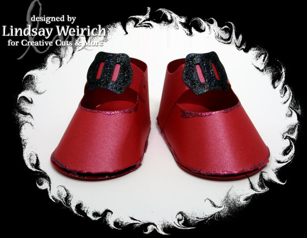 Don't forget the ruby slippers! These were cut from Metallic red cardstock, I stickled the buckles and glued them on.